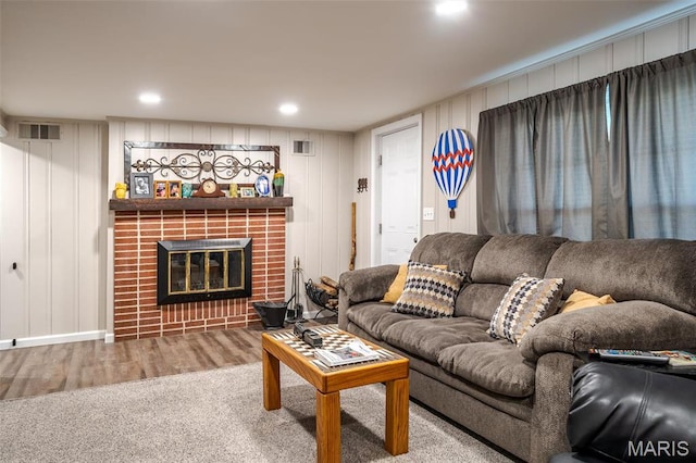 729 W State St, Union, MO 63084 - living area featuring wood finished floors, a decorative wall, and a brick fireplace
