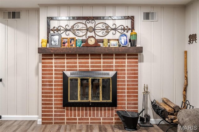 729 W State St, Union, MO 63084 - detailed view of a brick fireplace, wood finished floors, and a decorative wall