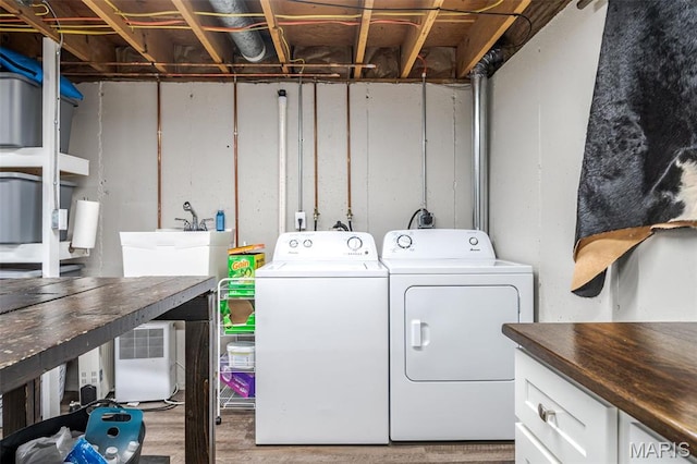 729 W State St, Union, MO 63084 - laundry room with washer and dryer, wood finished floors, and cabinet space
