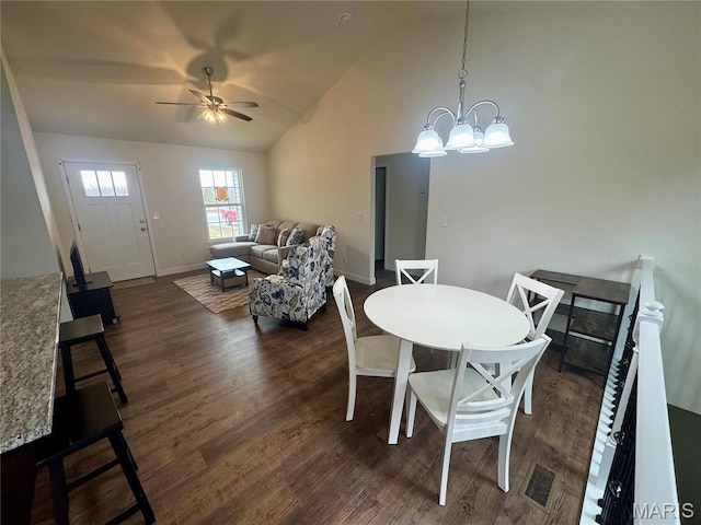 282 Railroad St, Moscow Mills, MO 63362 - dining area with baseboards, dark wood-style floors, a ceiling fan, high vaulted ceiling, and a chandelier