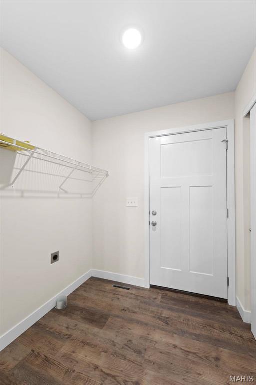 282 Railroad St, Moscow Mills, MO 63362 - laundry area with electric dryer hookup, baseboards, and dark wood-type flooring