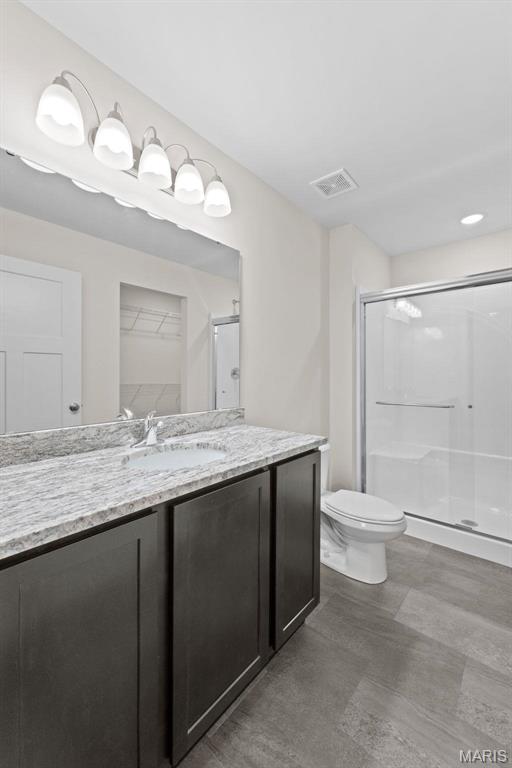 282 Railroad St, Moscow Mills, MO 63362 - bathroom featuring a stall shower, vanity, and toilet