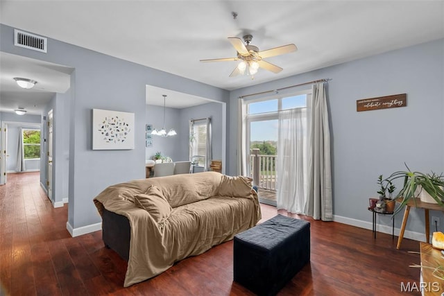 1239 Gardens Circle Dr Unit I, Saint Louis, MO 63125 - living room with baseboards, wood finished floors, a ceiling fan, and a chandelier