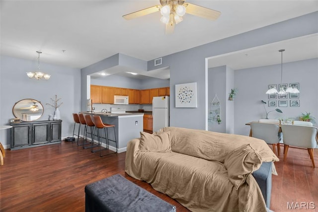 1239 Gardens Circle Dr Unit I, Saint Louis, MO 63125 - living room with a chandelier, dark wood-type flooring, and ceiling fan