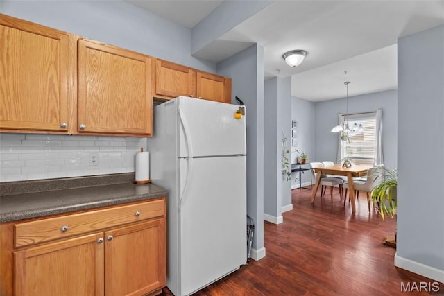 1239 Gardens Circle Dr Unit I, Saint Louis, MO 63125 - kitchen featuring freestanding refrigerator, dark countertops, backsplash, and baseboards