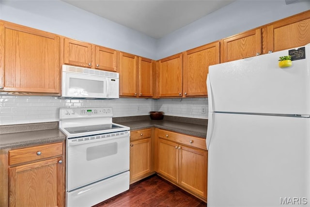 1239 Gardens Circle Dr Unit I, Saint Louis, MO 63125 - kitchen featuring white appliances, dark countertops, decorative backsplash, and dark wood finished floors
