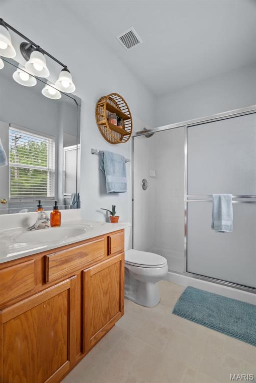 1239 Gardens Circle Dr Unit I, Saint Louis, MO 63125 - bathroom featuring vanity, a stall shower, and toilet