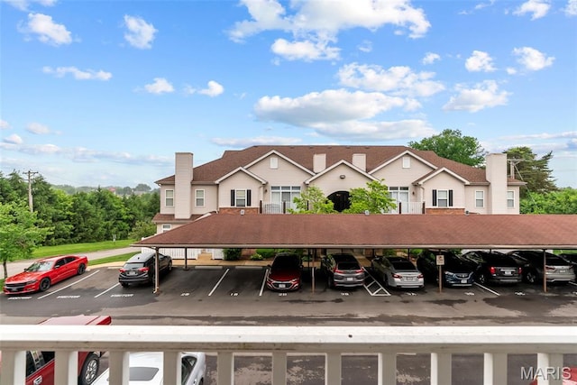 1239 Gardens Circle Dr Unit I, Saint Louis, MO 63125 - view of building exterior featuring covered parking