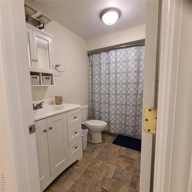 8 Nathan St, Waynesville, MO 65583 - full bath with toilet, stone finish floors, vanity, and a shower with shower curtain