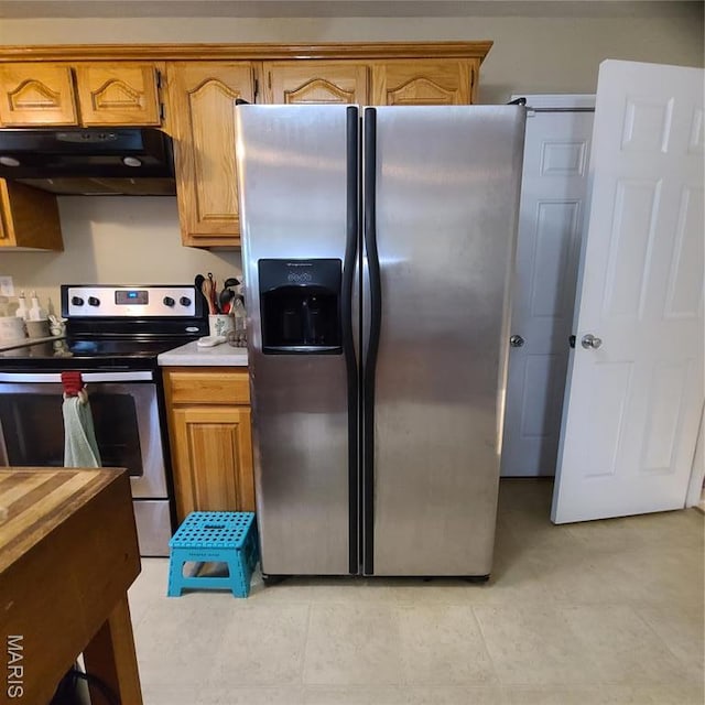 8 Nathan St, Waynesville, MO 65583 - kitchen with under cabinet range hood, stainless steel appliances, light countertops, and brown cabinets