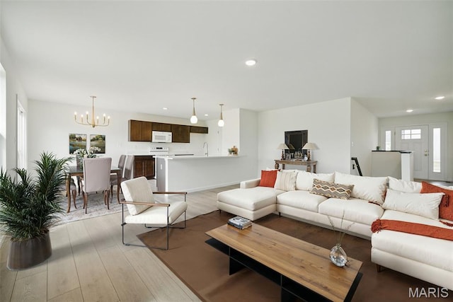 114 Harrow Dr, Ofallon, MO 63385 - living area with light wood-type flooring, a chandelier, and recessed lighting