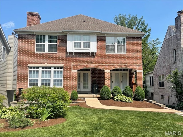 520 E Dr, Saint Louis, MO 63130 - view of front of house featuring brick siding, a chimney, a front yard, and a shingled roof