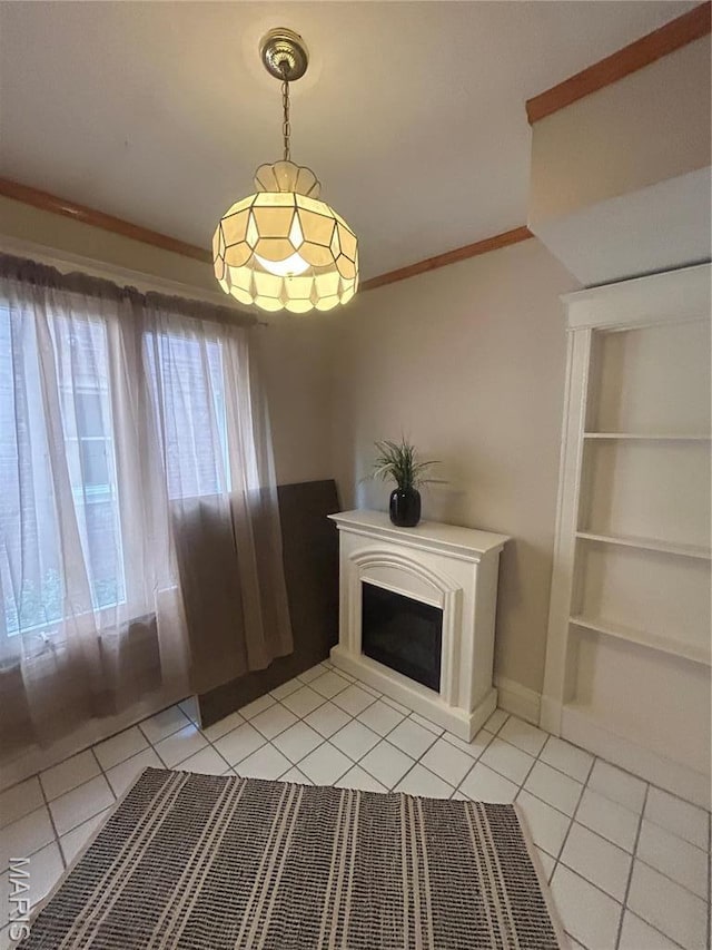 740 Heman Ave, Saint Louis, MO 63130 - unfurnished dining area featuring light tile patterned floors, a fireplace, crown molding, and built in shelves