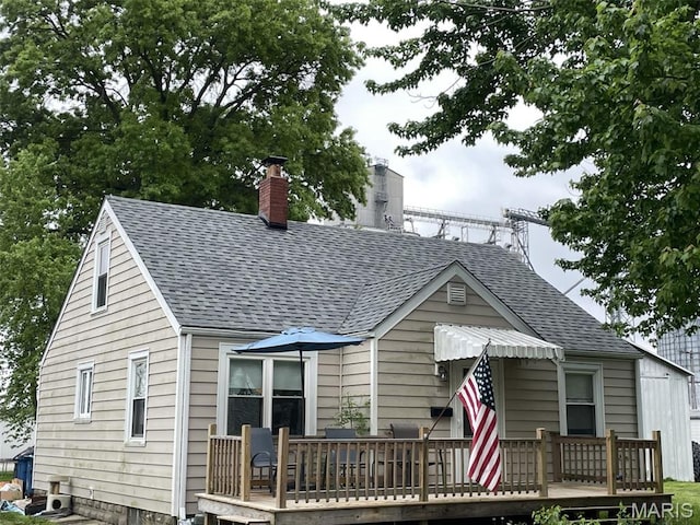 308 S Cedar St, Trenton, IL 62293 - view of front of house featuring a wooden deck, a shingled roof, and a chimney