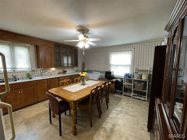 308 S Cedar St, Trenton, IL 62293 - dining area with plenty of natural light, a ceiling fan, light flooring, and wallpapered walls