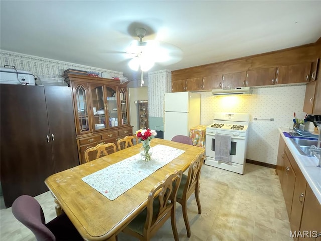 308 S Cedar St, Trenton, IL 62293 - dining area with a ceiling fan and wallpapered walls