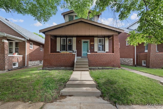 5245 Robert Ave, Saint Louis, MO 63109 - bungalow-style house featuring a front yard, covered porch, and brick siding