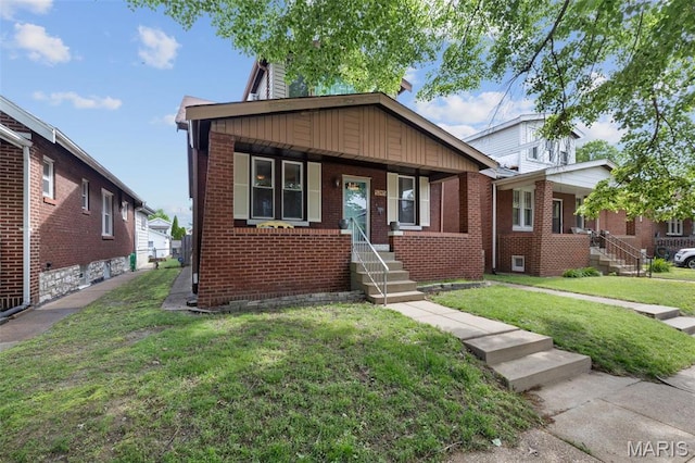 5245 Robert Ave, Saint Louis, MO 63109 - bungalow with brick siding, a front lawn, and a chimney