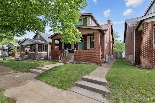 5245 Robert Ave, Saint Louis, MO 63109 - bungalow with a porch, a front lawn, and brick siding