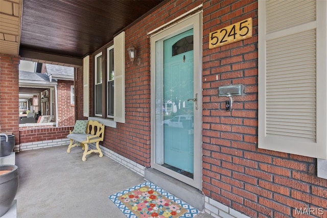 5245 Robert Ave, Saint Louis, MO 63109 - doorway to property with a porch and brick siding