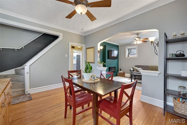 5245 Robert Ave, Saint Louis, MO 63109 - dining area with a ceiling fan, stairs, light wood-type flooring, baseboards, and crown molding