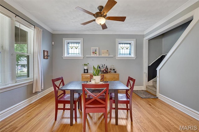 5245 Robert Ave, Saint Louis, MO 63109 - dining space with healthy amount of natural light, light wood-type flooring, stairway, and ornamental molding