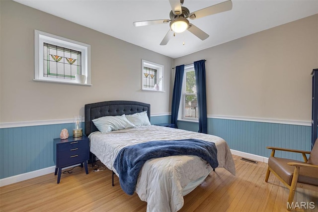 5245 Robert Ave, Saint Louis, MO 63109 - bedroom with wood finished floors, a wainscoted wall, baseboards, and ceiling fan