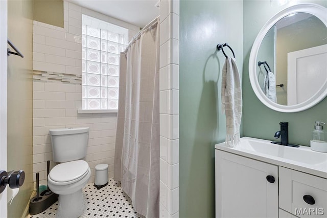5245 Robert Ave, Saint Louis, MO 63109 - bathroom featuring toilet, tile walls, curtained shower, and vanity