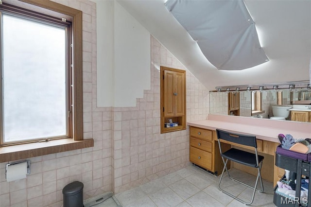 5245 Robert Ave, Saint Louis, MO 63109 - bathroom with tile walls, tile patterned floors, toilet, vanity, and lofted ceiling