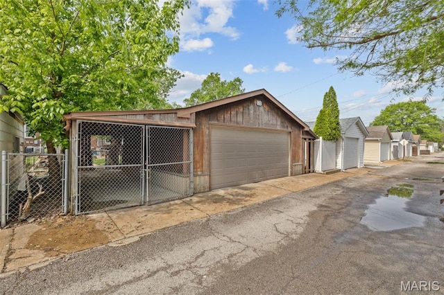 5245 Robert Ave, Saint Louis, MO 63109 - view of front of property featuring a detached garage, fence, and a gate