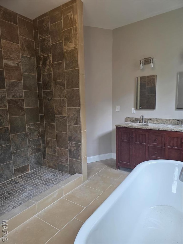 5614 Etzel Ave, Saint Louis, MO 63112 - full bathroom featuring a freestanding tub, double vanity, tile patterned floors, baseboards, and a tile shower