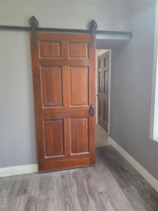 5614 Etzel Ave, Saint Louis, MO 63112 - detailed view of a barn door, wood finished floors, and baseboards