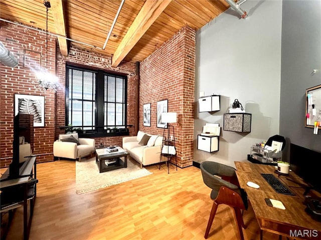 1113 Washington Ave Unit 312, Saint Louis, MO 63101 - living area with brick wall, wood ceiling, wood finished floors, beam ceiling, and a towering ceiling