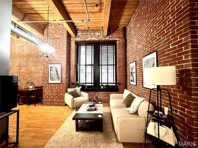 1113 Washington Ave Unit 312, Saint Louis, MO 63101 - living area featuring wooden ceiling, brick wall, wood finished floors, and beamed ceiling