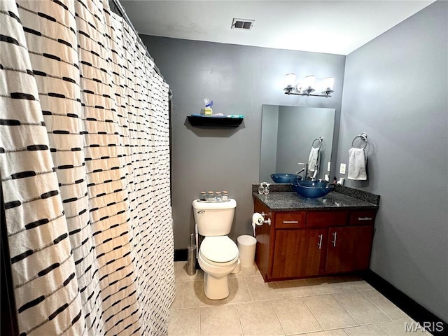 1113 Washington Ave Unit 312, Saint Louis, MO 63101 - bathroom featuring toilet, tile patterned floors, baseboards, and vanity