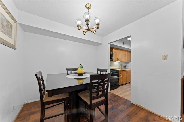 11151 Whispering Oaks Dr, Saint Louis, MO 63136 - dining area featuring a chandelier, wood finished floors, and baseboards