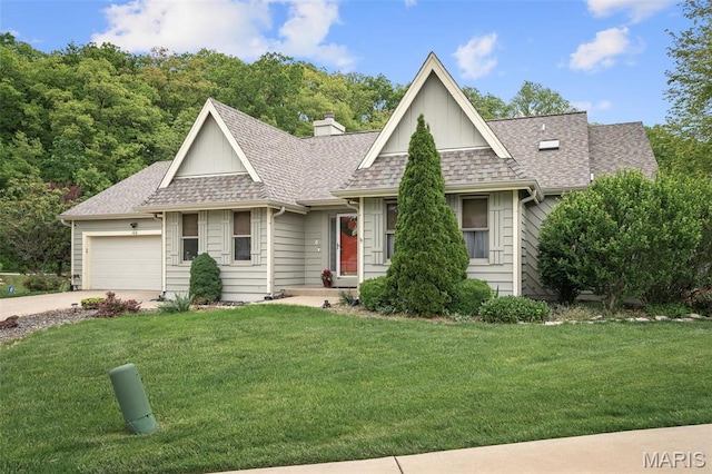108 Antoinette Ter, Lake St Louis, MO 63367 - view of front of house featuring a shingled roof, a front lawn, driveway, and an attached garage
