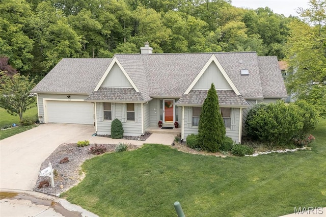 108 Antoinette Ter, Lake St Louis, MO 63367 - view of front of house with a shingled roof, driveway, an attached garage, and a front lawn