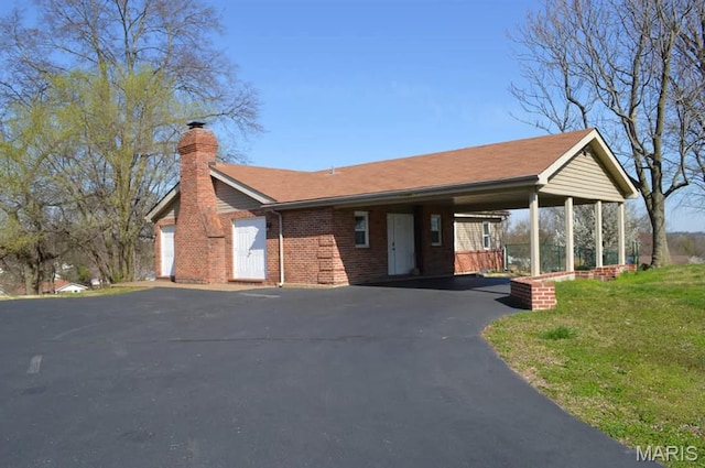 1200 Auber Dr, Manchester, MO 63011 - ranch-style house featuring a chimney, asphalt driveway, brick siding, and an attached carport