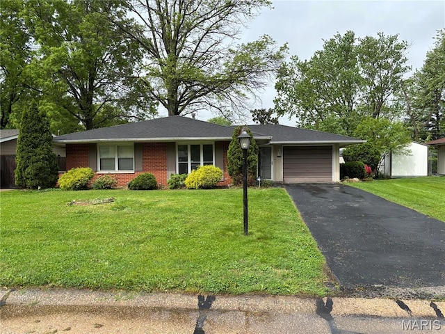 213 Todd Ln, Belleville, IL 62221 - ranch-style house with an attached garage, driveway, brick siding, and a front yard