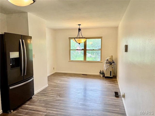 213 Todd Ln, Belleville, IL 62221 - unfurnished dining area featuring baseboards and dark wood-type flooring