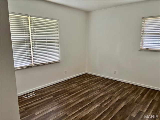 213 Todd Ln, Belleville, IL 62221 - empty room featuring dark wood-style flooring and baseboards