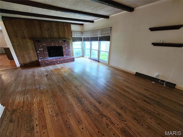 4241 State Route 162, Granite City, IL 62040 - unfurnished living room featuring beamed ceiling, hardwood / wood-style flooring, baseboards, and a fireplace