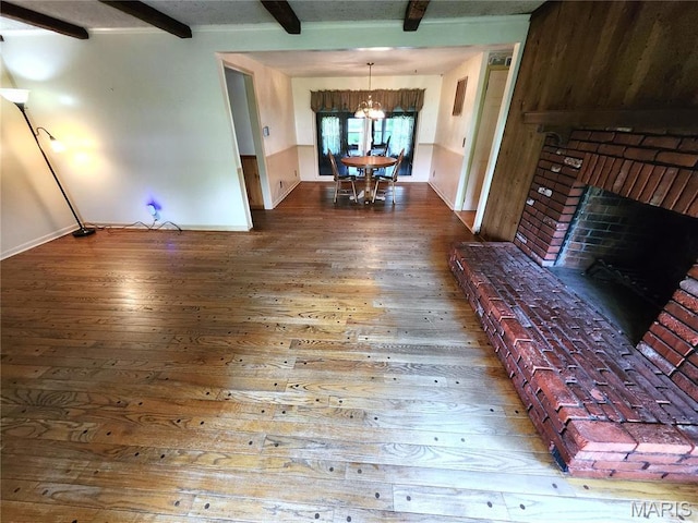 4241 State Route 162, Granite City, IL 62040 - living room featuring wood-type flooring, beam ceiling, a chandelier, baseboards, and a brick fireplace