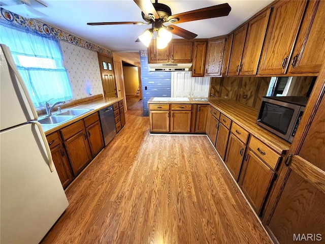 4241 State Route 162, Granite City, IL 62040 - kitchen featuring stainless steel appliances, a sink, brown cabinetry, under cabinet range hood, and light wood-style flooring