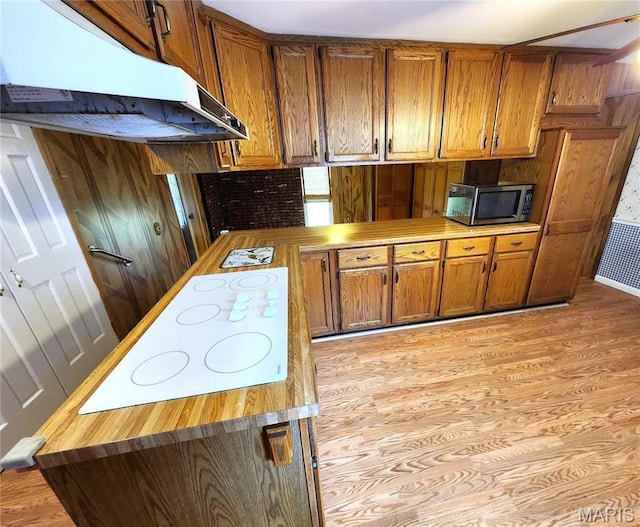 4241 State Route 162, Granite City, IL 62040 - kitchen featuring stainless steel microwave, under cabinet range hood, brown cabinets, white electric stovetop, and light wood-style floors