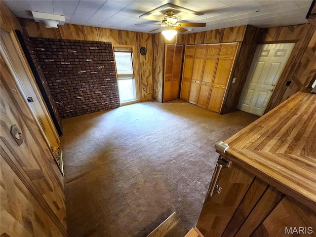 4241 State Route 162, Granite City, IL 62040 - unfurnished bedroom featuring wood walls, light colored carpet, and a ceiling fan