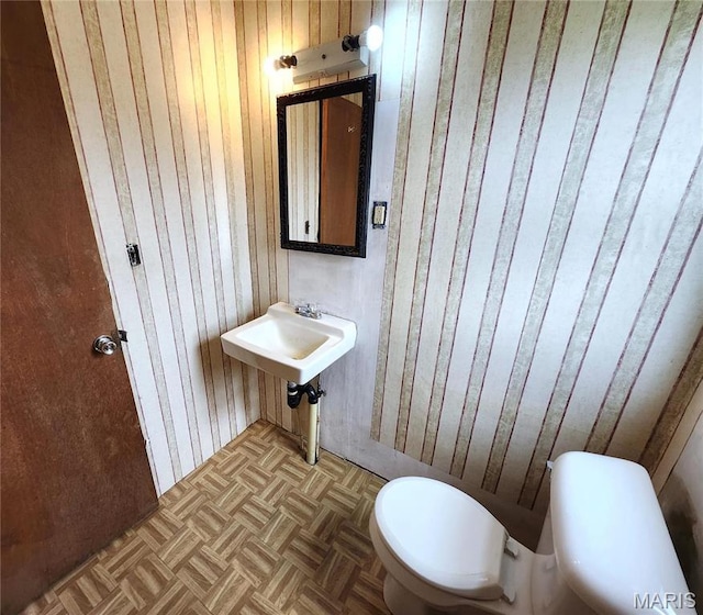4241 State Route 162, Granite City, IL 62040 - half bathroom featuring wood walls, toilet, and a sink