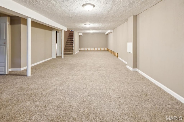 6363 Coventry Dr, Florissant, MO 63033 - finished below grade area featuring carpet flooring, a textured ceiling, baseboards, and stairs