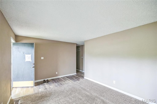 6363 Coventry Dr, Florissant, MO 63033 - spare room featuring carpet, baseboards, and a textured ceiling